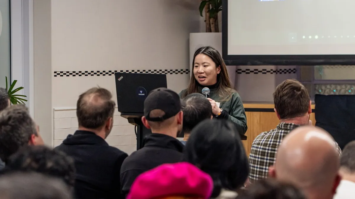 Yong Kheng presenting at the Adelaide Claude Code Meetup at Stone & Chalk, microphone in hand, to a seated audience